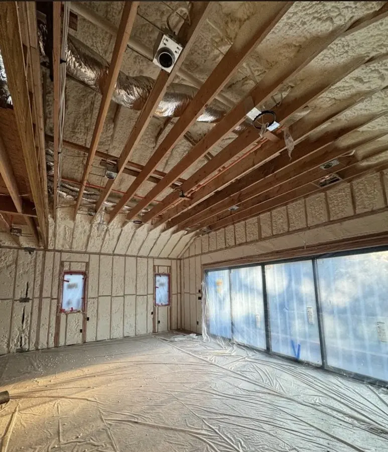 Interior walls and ceiling insulated with spray foam during new construction in Port Washington